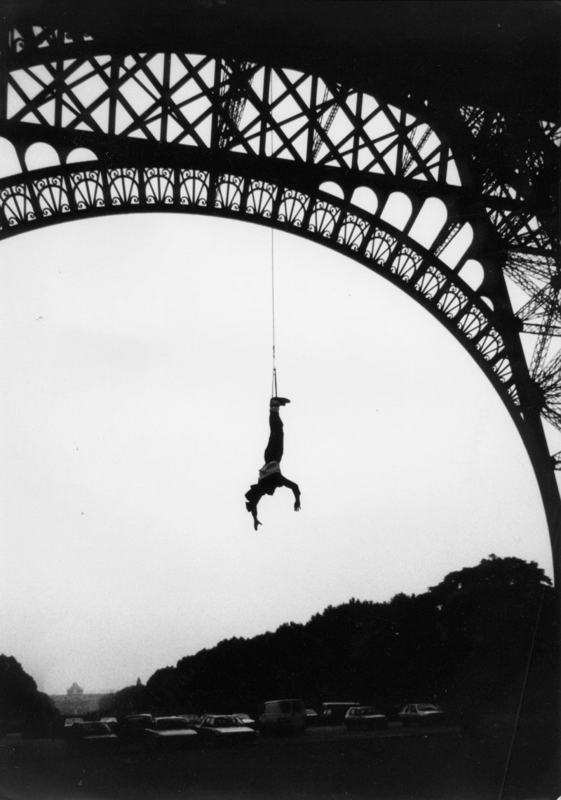 AJ Hackett leaping off the Eiffel Tower in 1987, showcasing his iconic bungy jump that launched his adventure career.