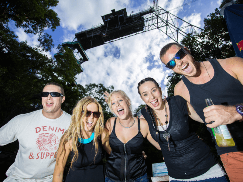 Five people enjoying their time, with a bungy tower visible above them.