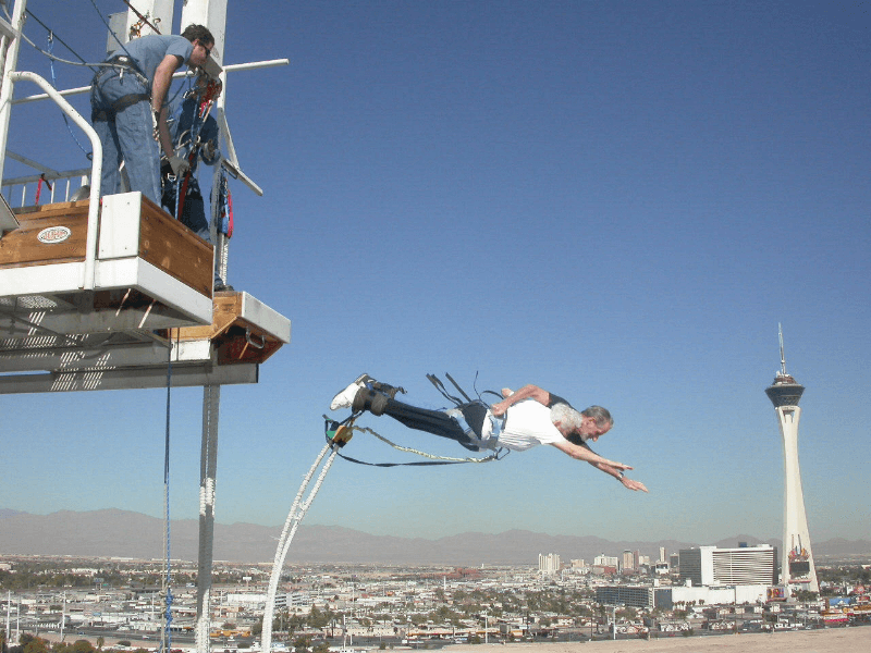 Tandem bungy jump off Macau Tower with two seniors, demonstrating the thrill and inclusivity of Skypark by AJ Hackett.